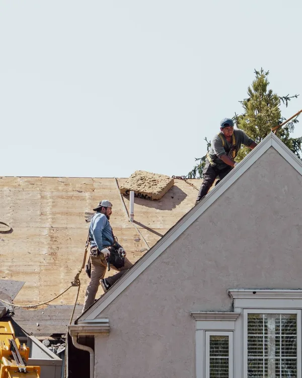 Green Ladder Roofing crew installing a new roof deck after storm damage in the foothills