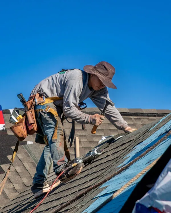 Pasadena roofing contractor hand-nailing shingles during a roof replacement