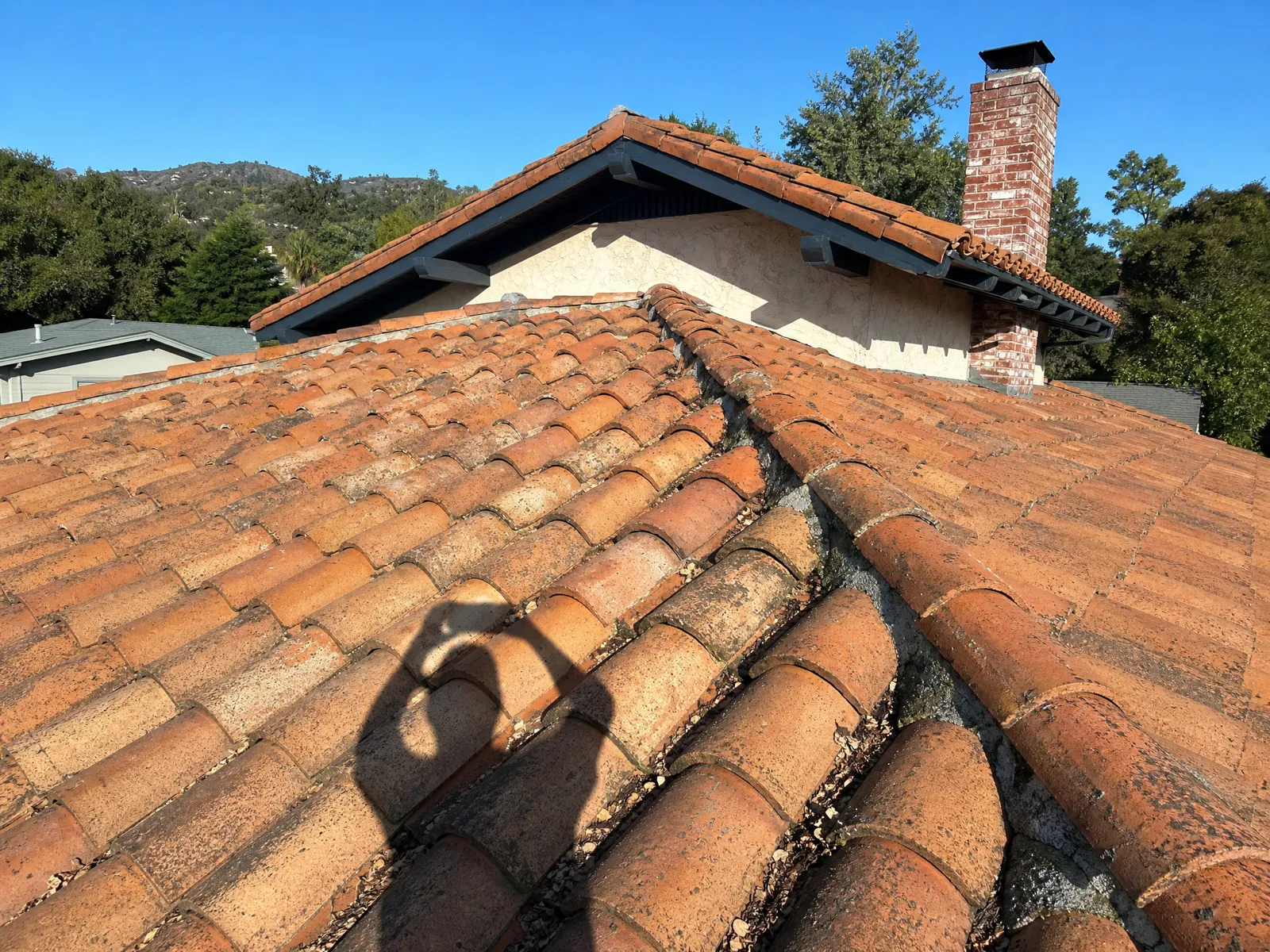 Cracked clay tile roof in San Marino, CA before restoration